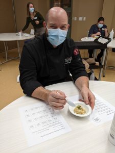 George Madalena, Culinary Specialist, was one of the judges, tasting a dish