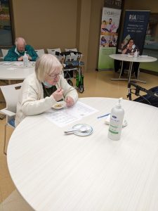 Charlotte Graham, a long-term care home resident, tasting a dish